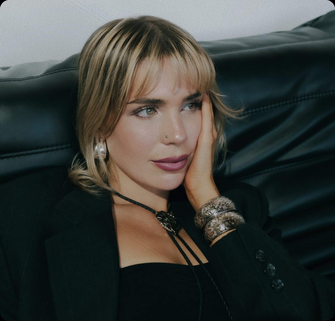 Claire Marie on a leather couch